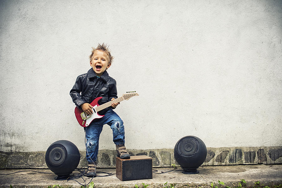 Little boy playing electric guitar Photograph by Imgorthand
