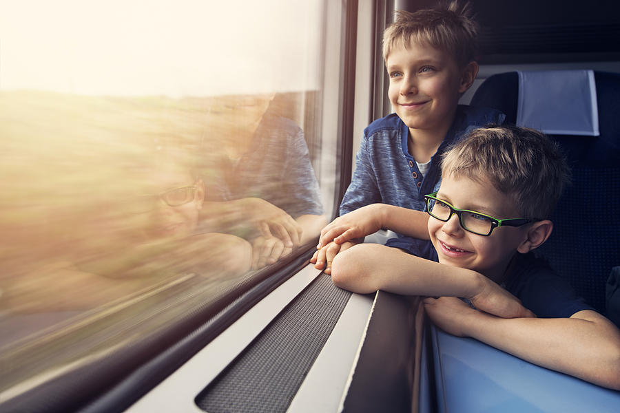 Little brotheres enjoying travelling by train Photograph by Imgorthand