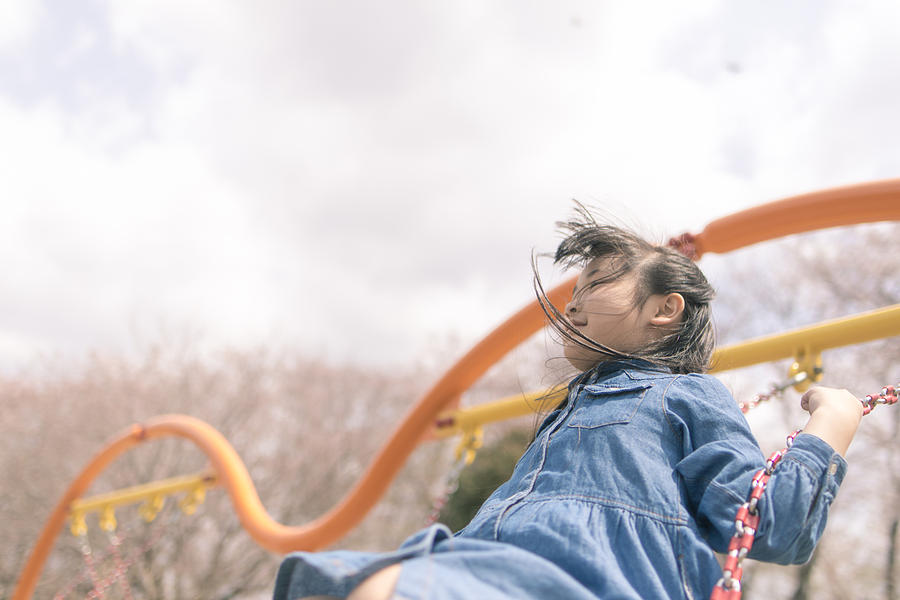 Little girl playing on swing Photograph by Satoshi-K