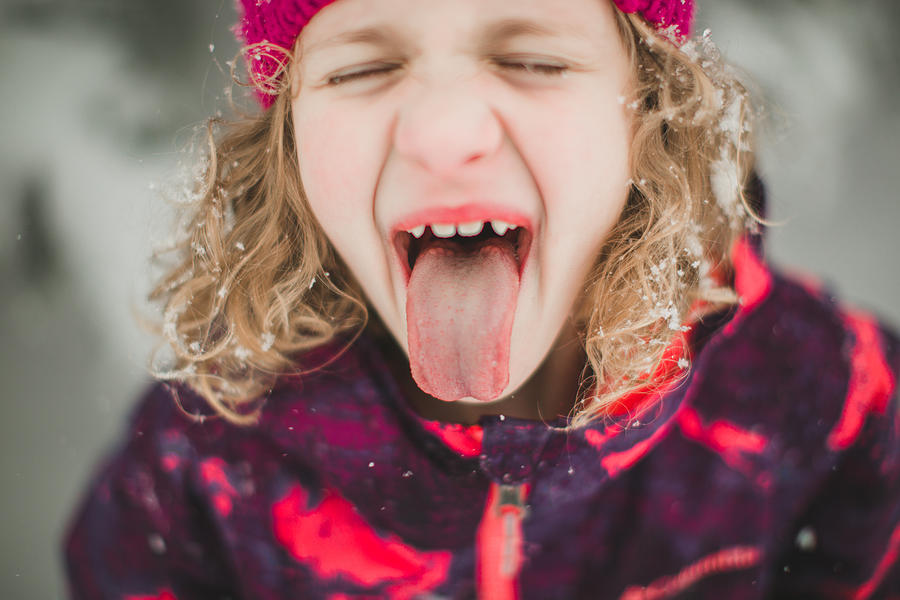 Little Girl trying to catch snowflakes Photograph by Annie Otzen