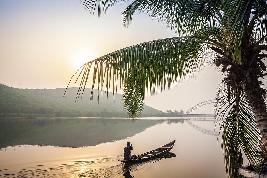Local paddling in wooden canoe, Volta River, Ghana Photograph by Jacek Sopotnicki