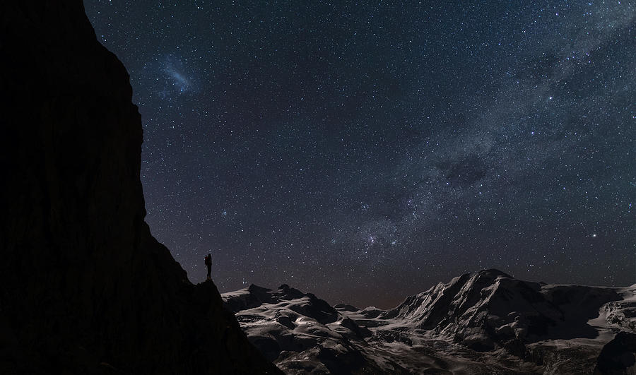 Lone climber watching stars in the sky Photograph by Buena Vista Images