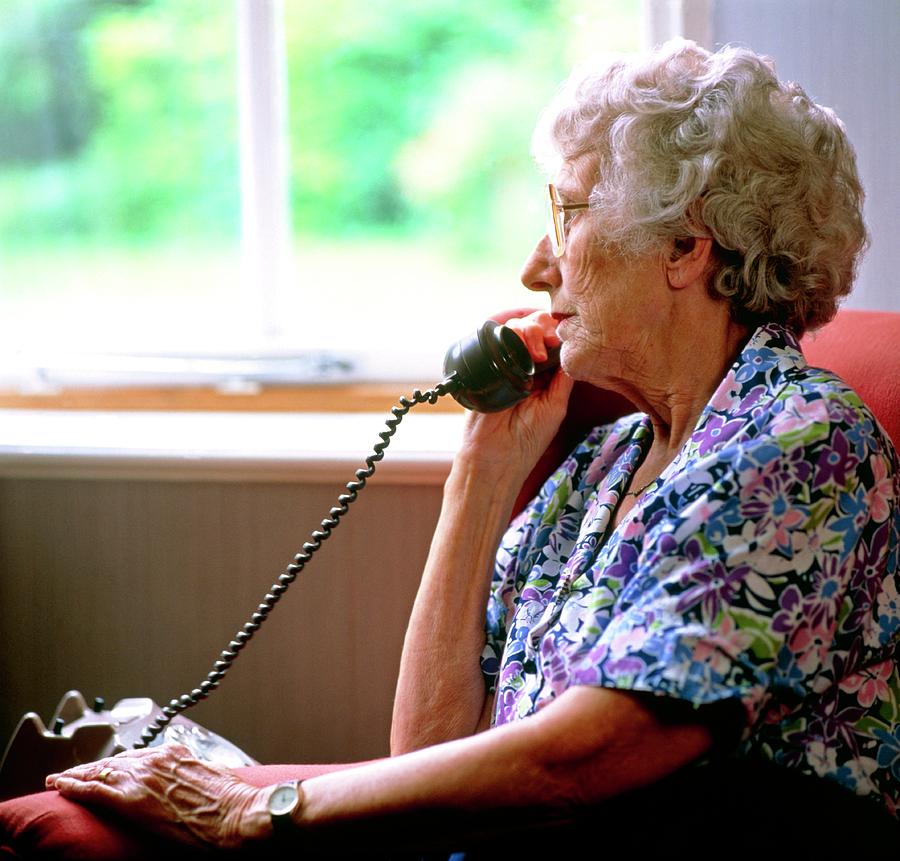 Loneliness: Elderly Woman Makes A Telephone Call Photograph by Sheila Terry/science Photo Library