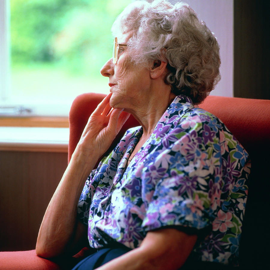 Loneliness: Elderly Woman Stares Out Of Window Photograph by Sheila Terry/science Photo Library