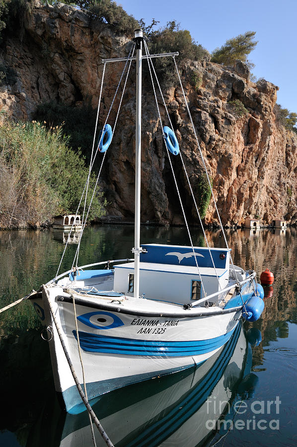 Lonely boat in Agios Nikolaos Photograph by George Atsametakis