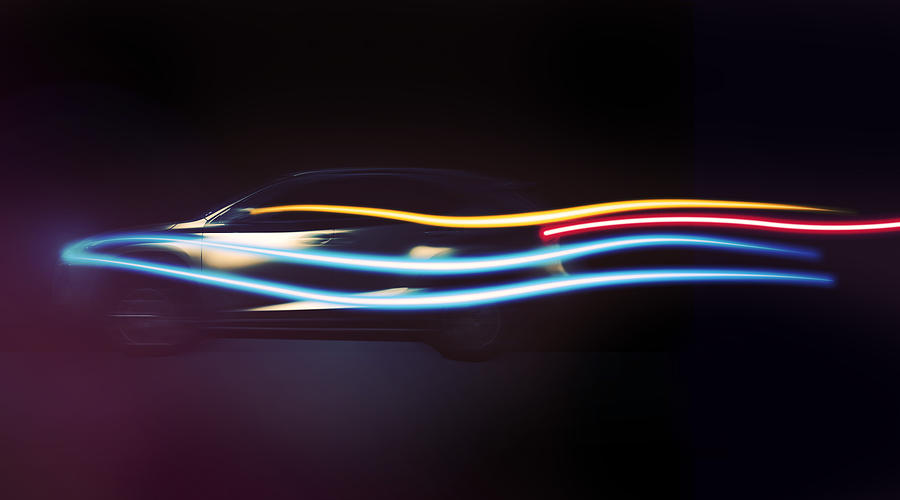 Long exposure of a beautiful SUV car with aerodynamic design in motion at night with colorful light trails in black background in a futuristic and creative picture. Photograph by Artur Debat
