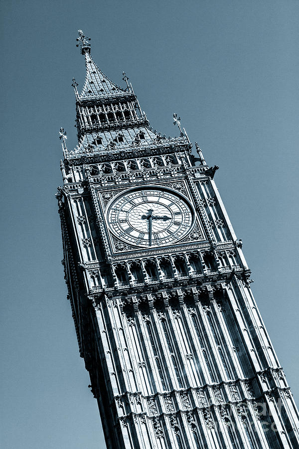 Looking up at Big Ben and clock against blue sky. Photograph by Peter Noyce