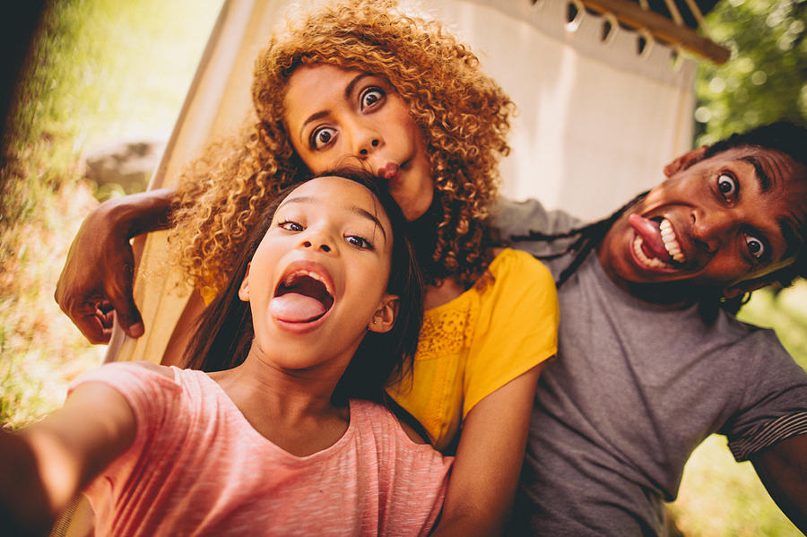 Lovely African-American family making silly faces and posing Photograph by Wundervisuals