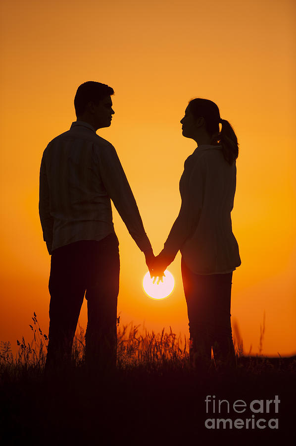 silhouette couple holding hands