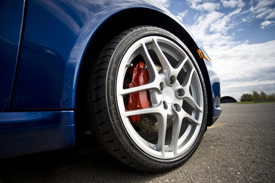 Low angle sports car tire Photograph by Pgiam