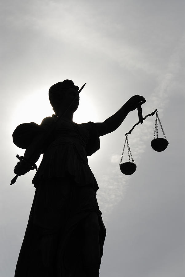 Low angle view of a silhouette of the statue Justitia Photograph by No_limit_pictures