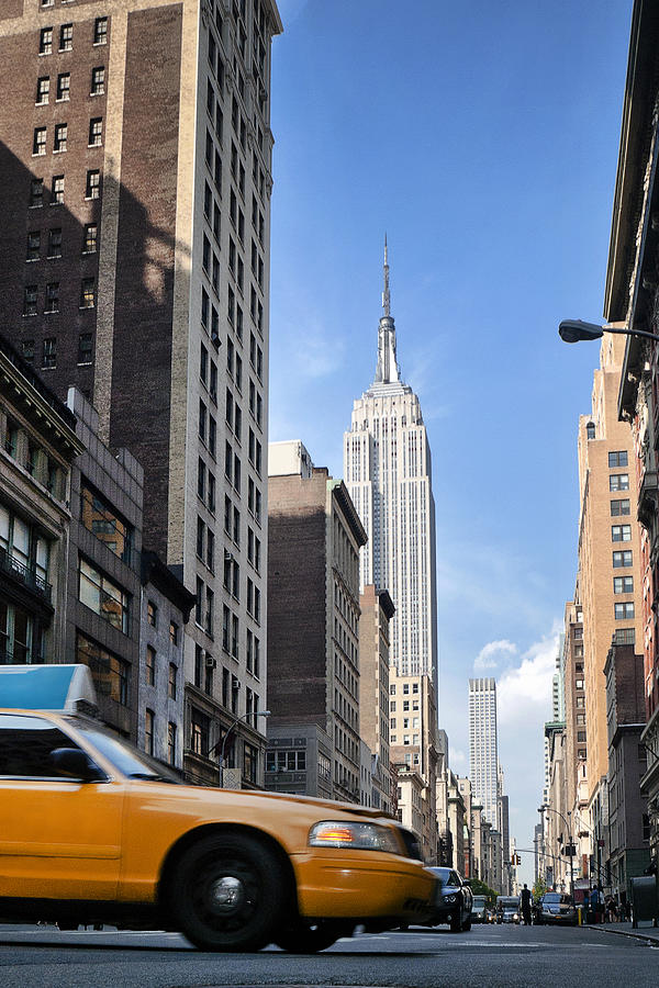 Low angle view of a yellow cab on 5th Avenue, Manhattan, New York, America, USA Photograph by Inigoarza