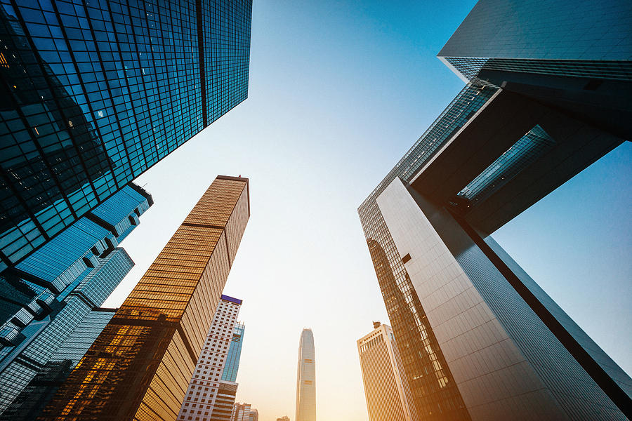 Low angle view of modern financial skyscrapers in Central Business District, Hong Kong at sunrise Photograph by D3sign