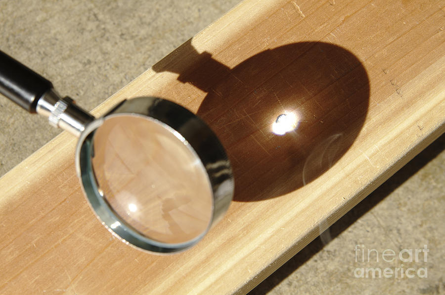 Magnifying Glass Focusing Sun Light Photograph by GIPhotoStock