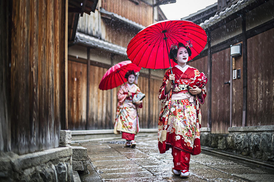Maikos walking in the streets of Kyoto Photograph by Xavierarnau