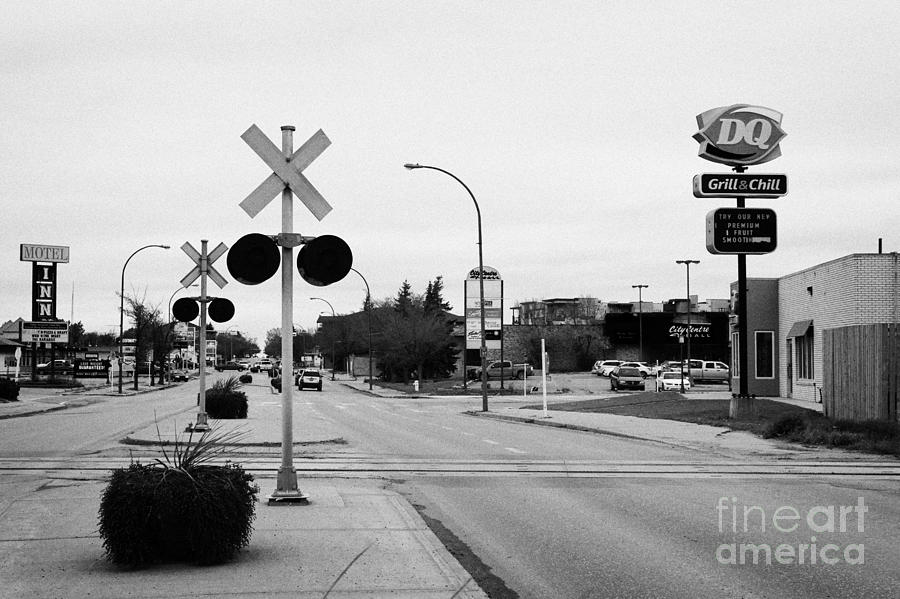 main road and railway crossing in downtown weyburn Saskatchewan Canada ...