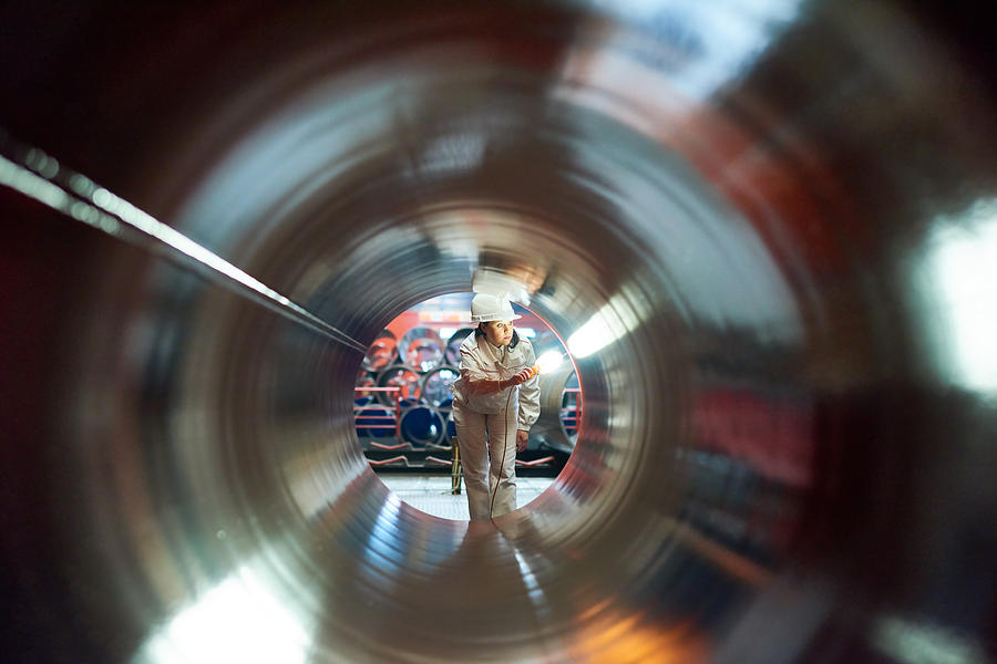 Maintenance engineer examining quality of tube Photograph by Mediaphotos
