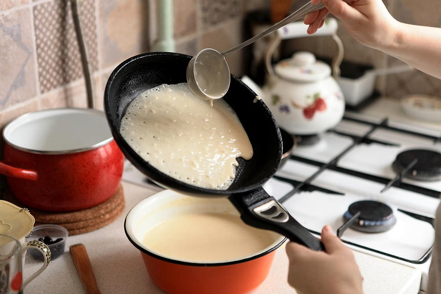 Making Pancakes on frying pan. Making Crepes on frying pan. Photograph by Ja_Het