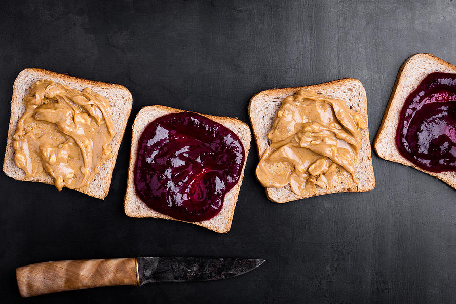 Making peanut butter and jelly sandwiches Photograph by Istetiana