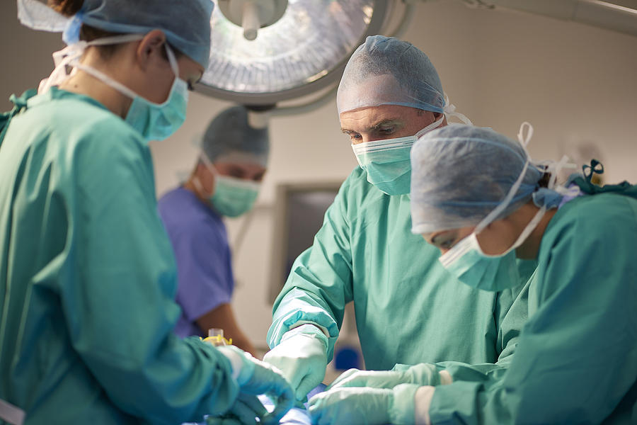 Male And Female Surgeon During An Operation Photograph by Sturti