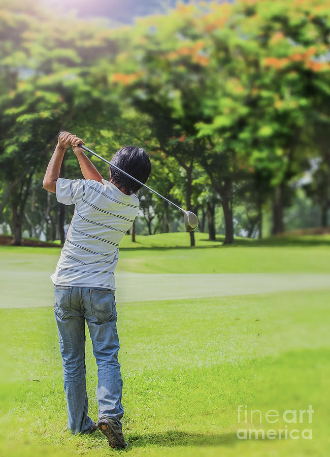 Golf Photograph - Male golf player teeing-off golf ball by Anek Suwannaphoom