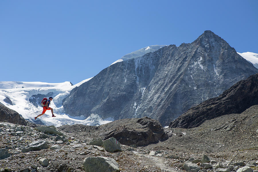 Male Hiker Jumping In Air In Mountains Photograph by Menno Boermans Male Hiker Jumping In Air In Mountains Photograph by Menno Boermans