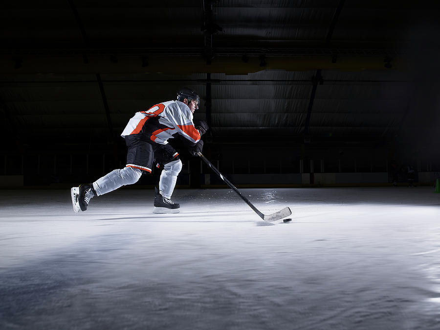 Male Ice Hockey Player Skating With Puck Photograph by Mike Harrington