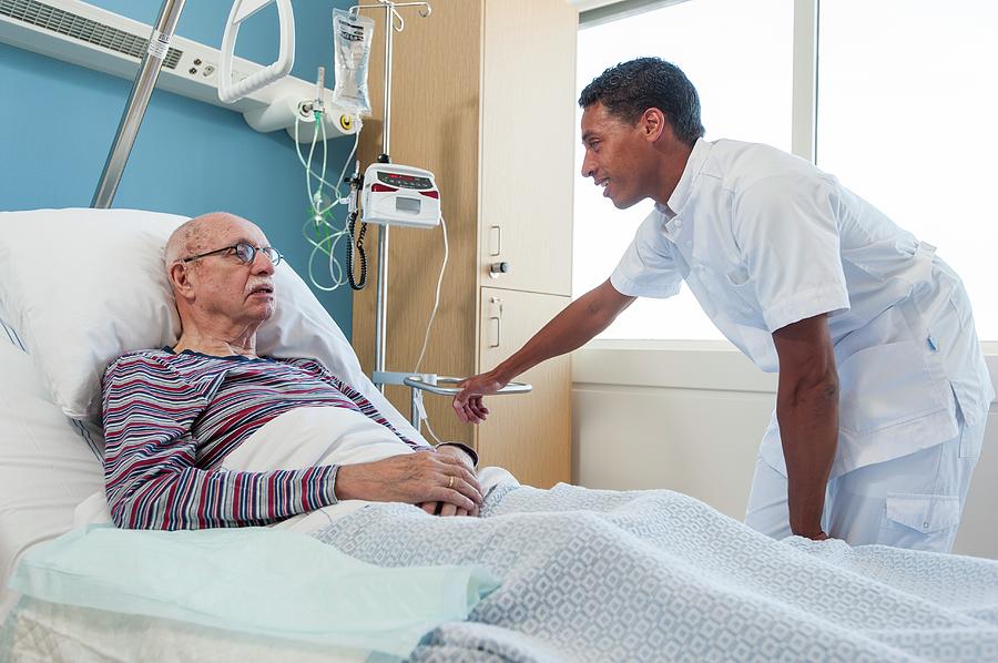 Male Nurse Talking To Senior Man Photograph by Arno Massee/science ...