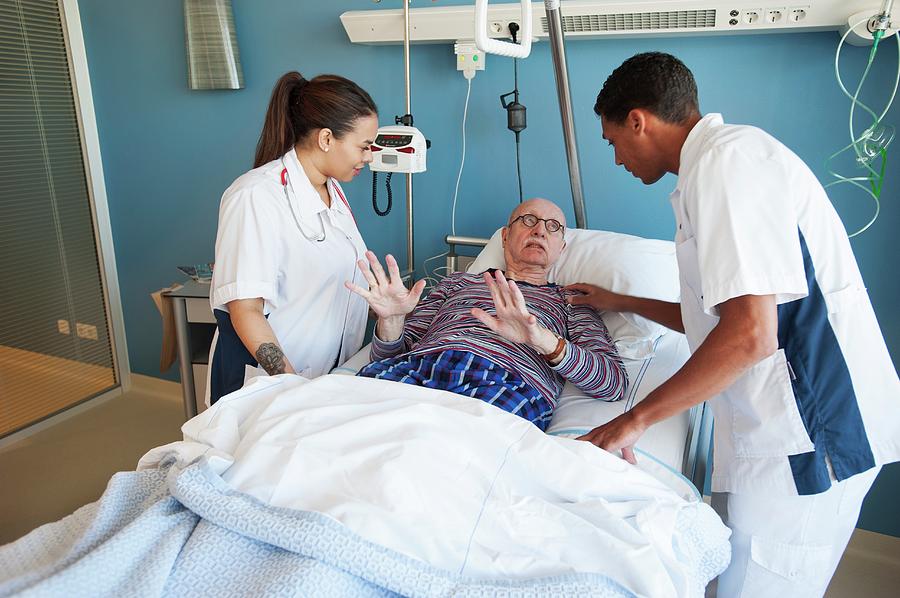 Male Patient In Distress With Two Nurses By Science Photo Library