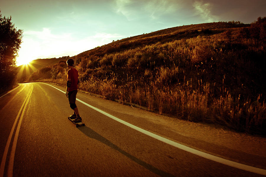 Sunset Photograph - Male Rides Long Board Down Paved Road by Gabe Rogel