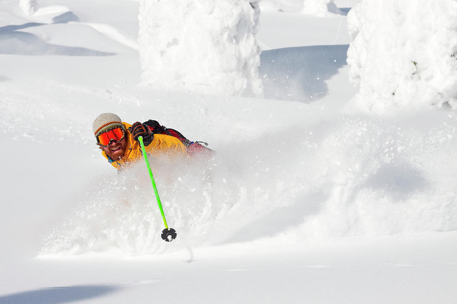 Holding Photograph - Male Skier Makes A Deep Powder Turn by Craig Moore Holding Photograph - Male Skier Makes A Deep Powder Turn by Craig Moore