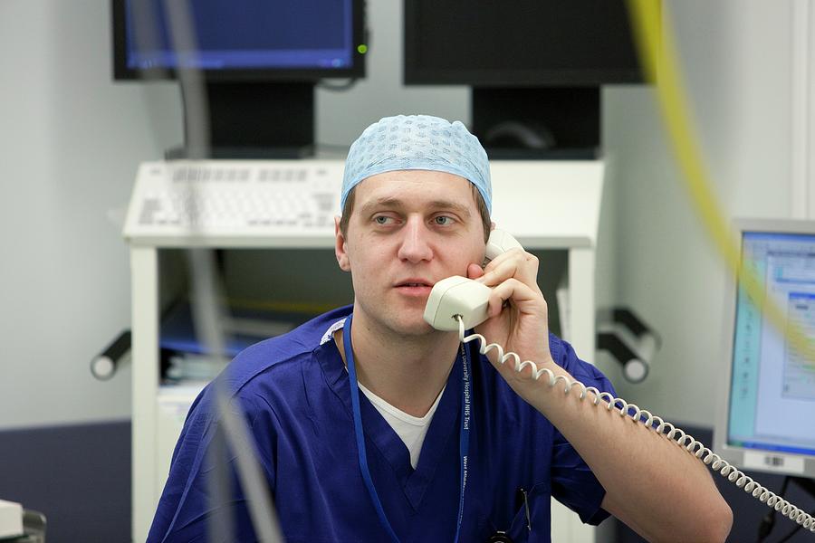 Male Surgeon On The Telephone Photograph by Mark Thomas/science Photo Library