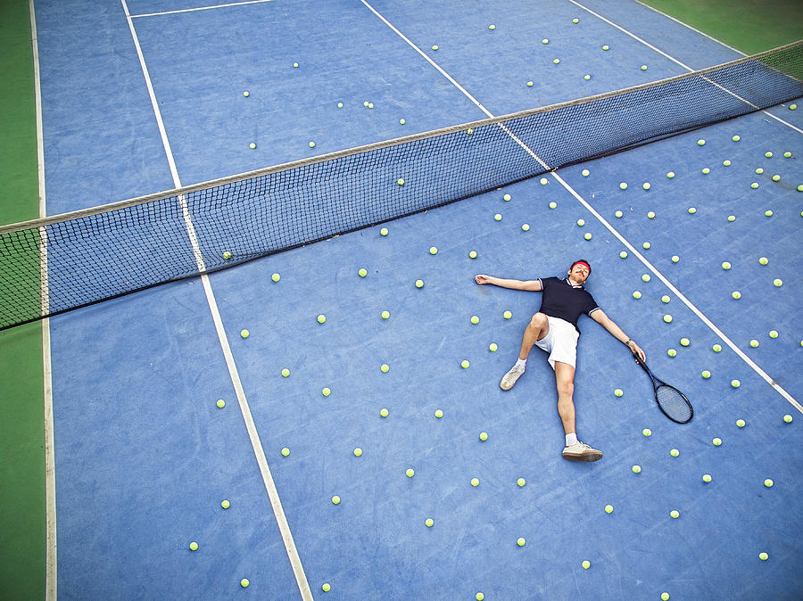 Male tennis player lying on ground Photograph by Orbon Alija