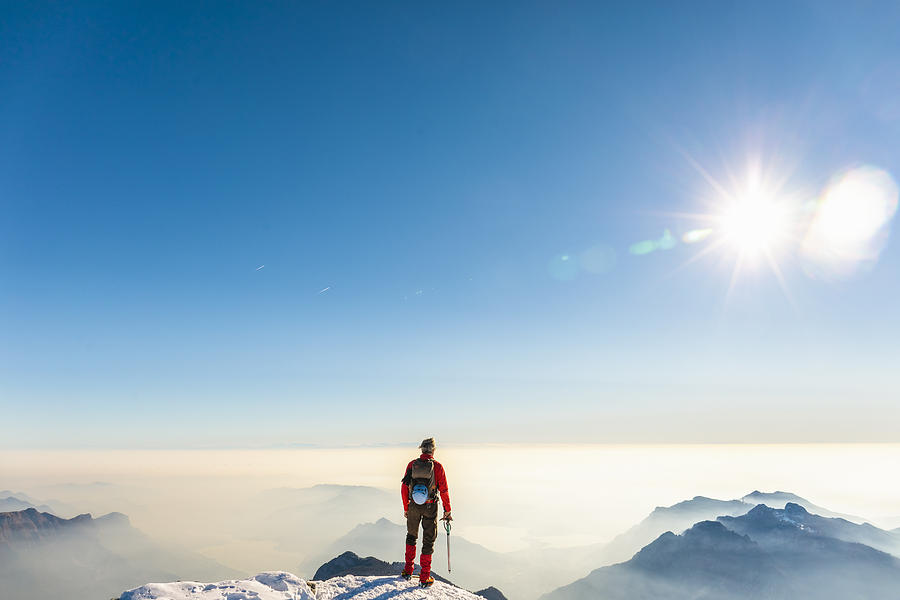 Man alpinist on top of the mountain Photograph by Massimo Colombo