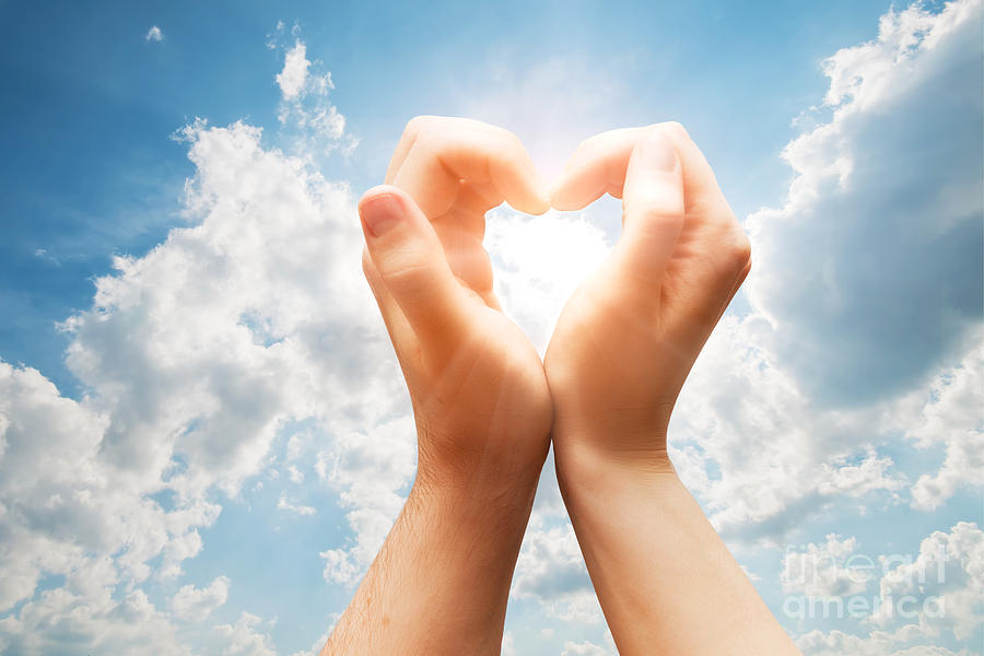 Summer Photograph - Man and woman hands make a heart on blue sunny sky by Michal Bednarek