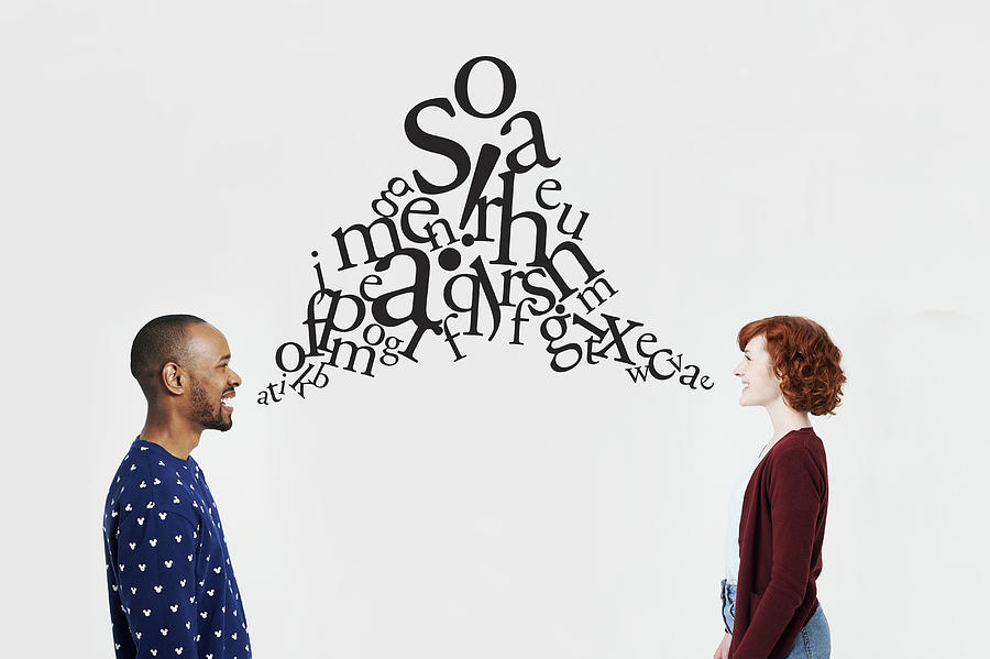 Man and woman with illustrated jumble of letters Photograph by Plume Creative