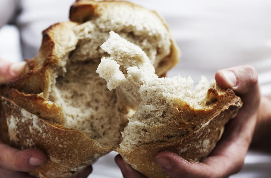 Man breaking bread  Photograph by Daniel Day