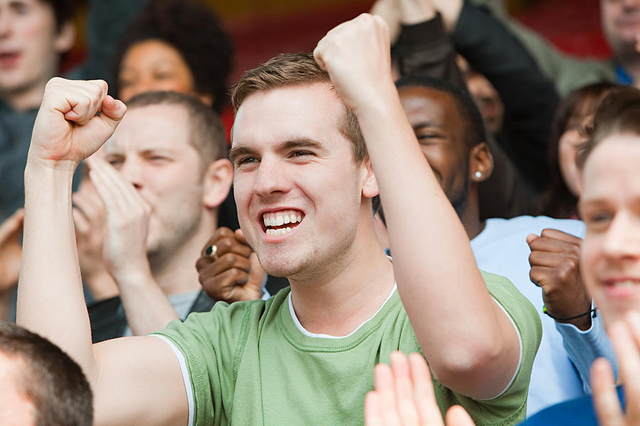 Man cheering at football match Photograph by Image Source
