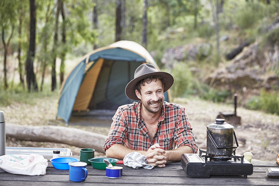 Man cooking and camping in Australian bush Photograph by Stuart Miller