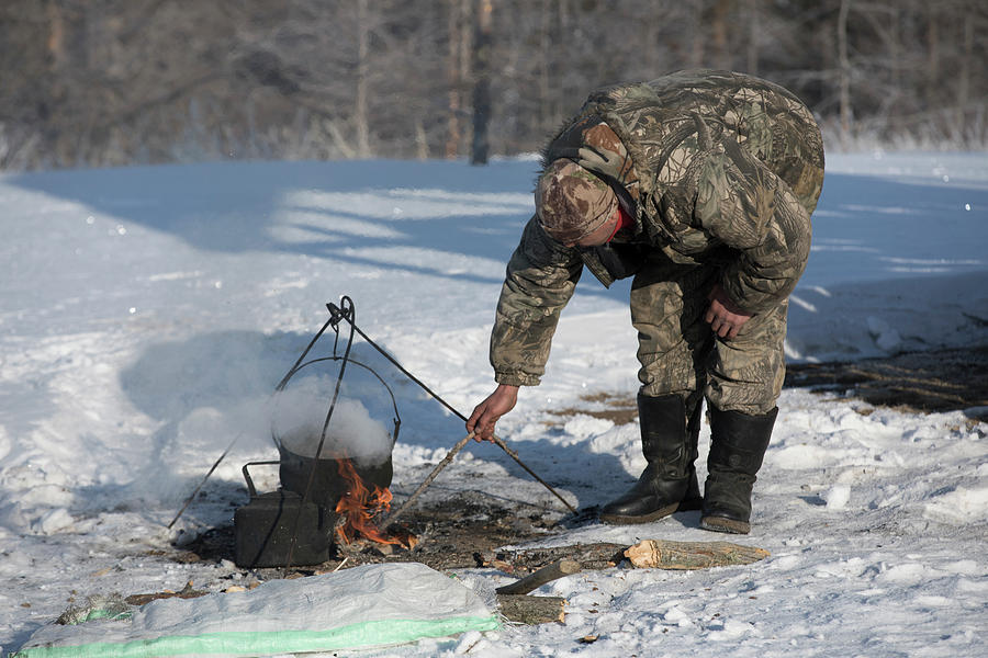 Man Cooking Over Campfire At Lake Photograph by Nestor Rodan | Fine Art ...