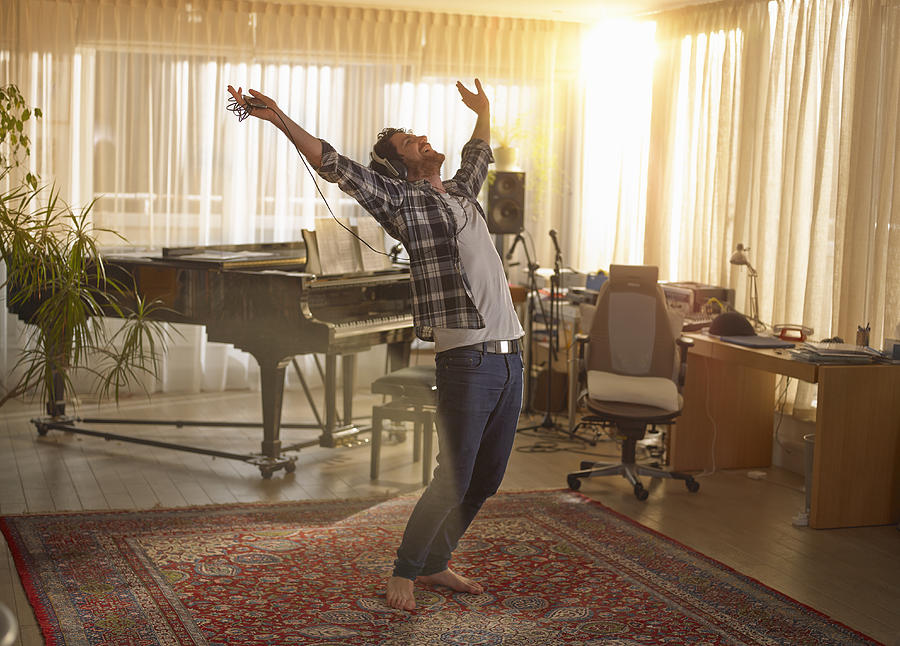 Man dancing with headphones on Photograph by 10000 Hours