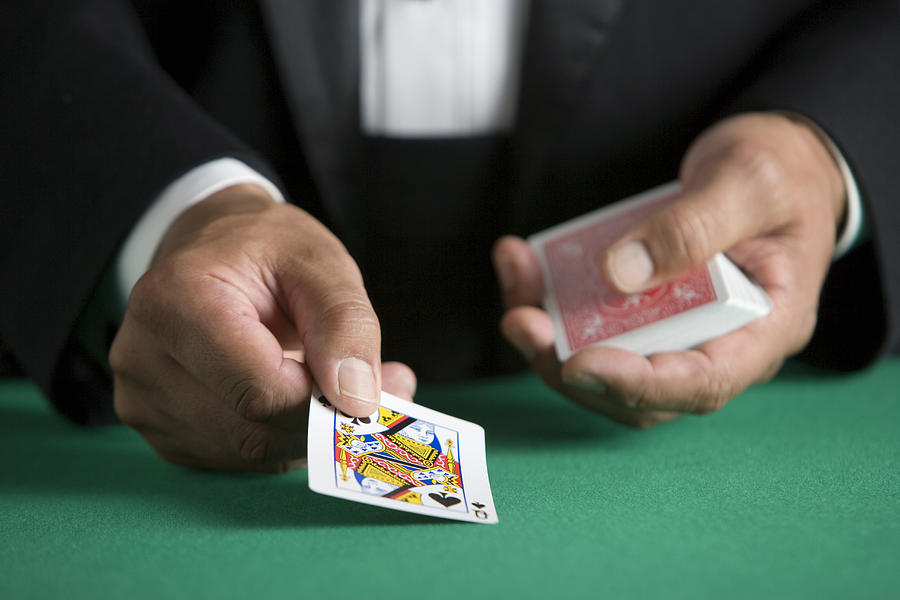 Man dealing deck of cards, close-up Photograph by Carlos Davila