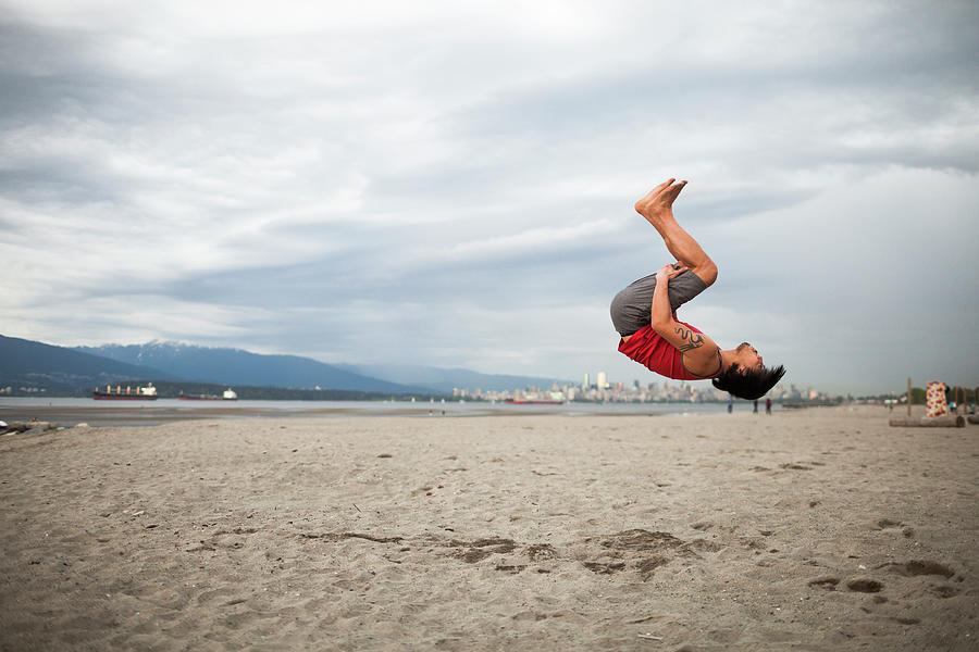 Man Doing Back Flip At Beach Photograph By Christopher Kimmel Pixels