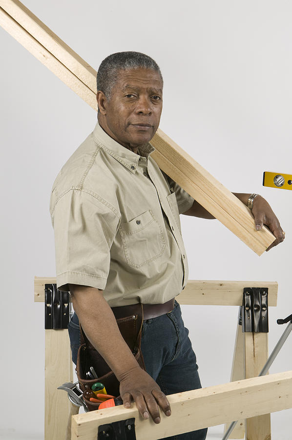 Man Doing Home Improvement, Carrying 2x4 Lumber Photograph by Lucidio Studio, Inc.