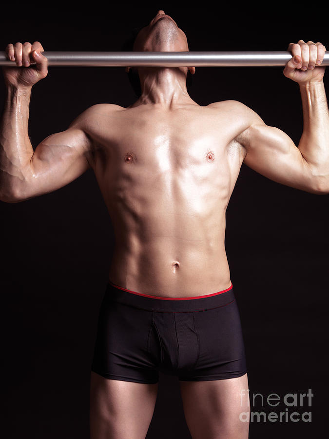 Sports Photograph - Man doing pullups on a pull up bar by Maxim Images Exquisite Prints
