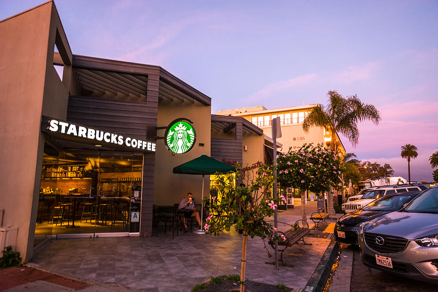 Man drinking coffee in Starbucks, La Jolla, USA Photograph by Anouchka