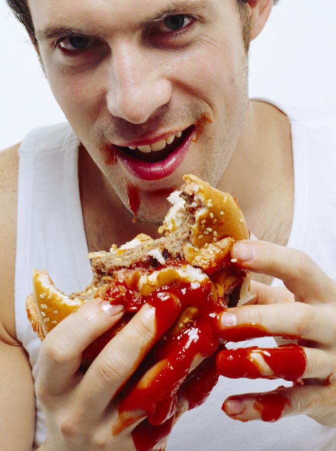 Man Eating Burger Photograph by Jason Kelvin/science Photo Libray