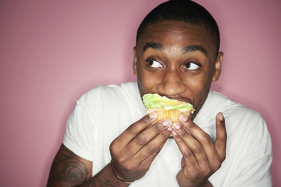 Man Eating Cupcake Photograph by Tara Moore