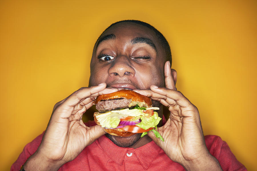 Man Eating Hamburger Photograph by Tara Moore