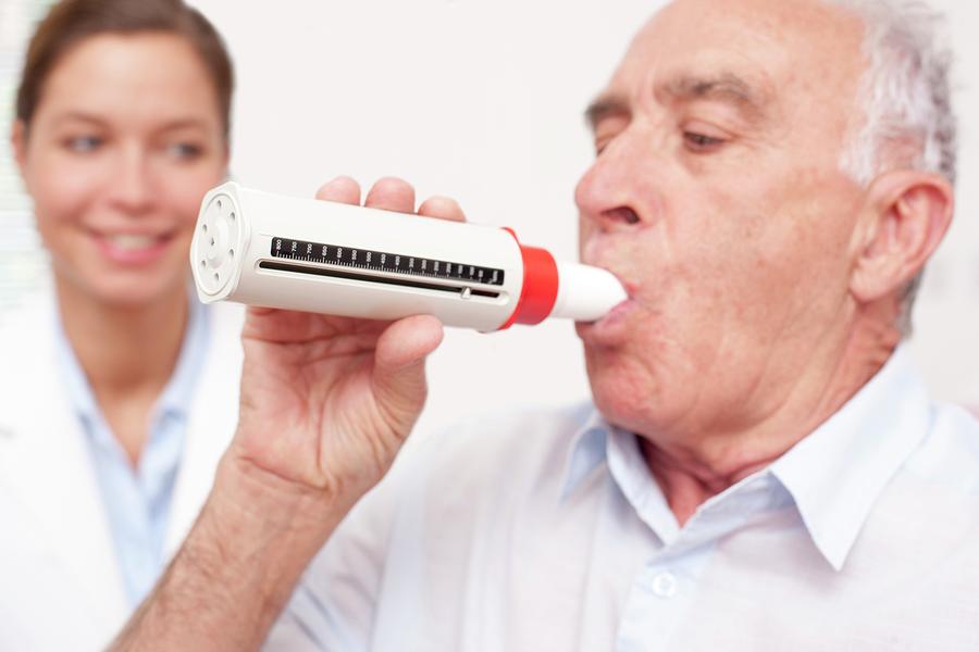 Man Exhaling Into A Peakflow Reader Photograph by Science Photo Library ...